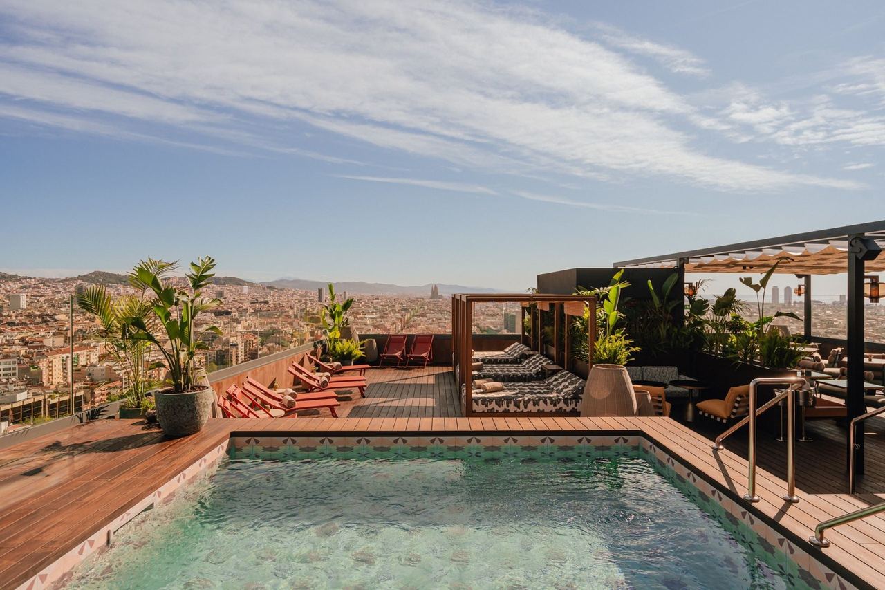 The rooftop pool at Nobu Hotel Barcelona, with loungers and cabanas over the city