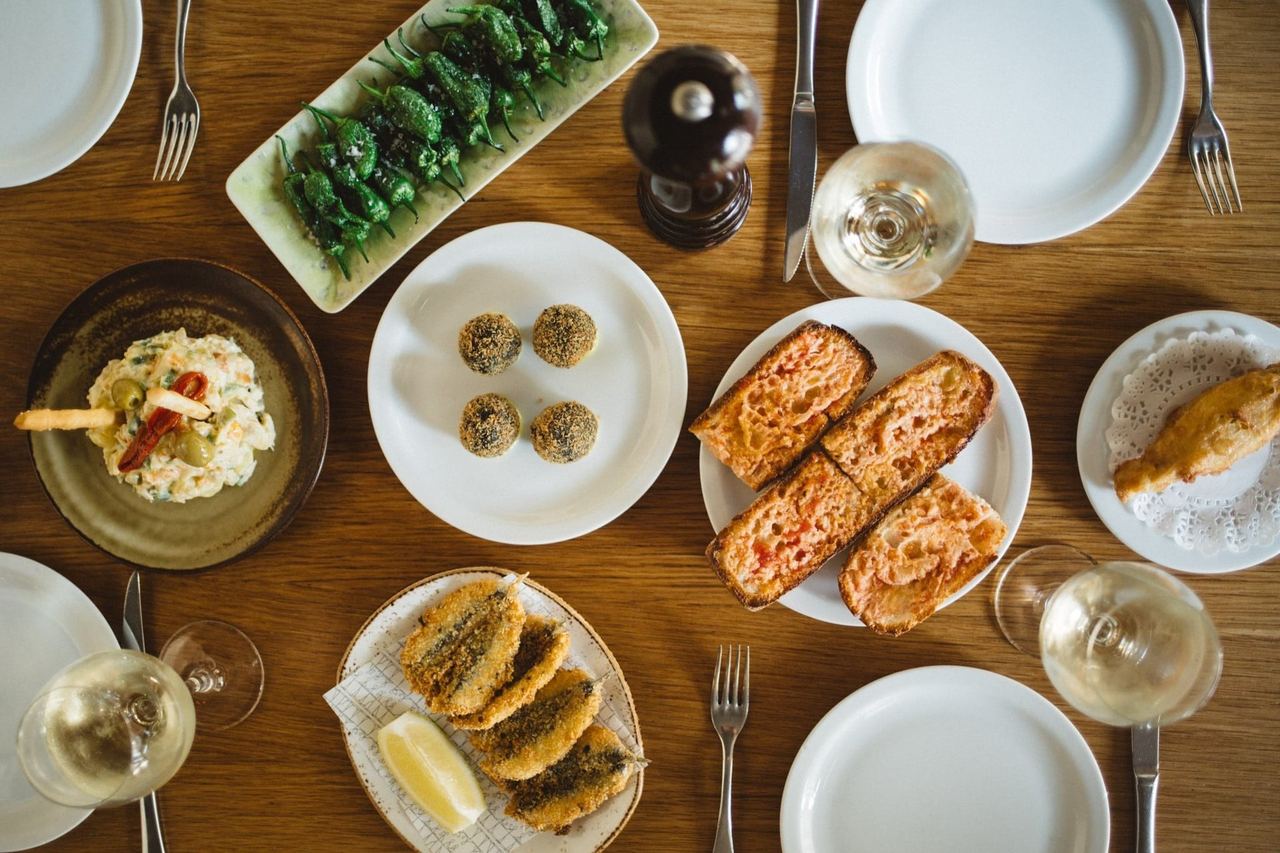 A spread of tapas at Paco Meralgo: pimientos de Padrón, pa amb tomàquet, fried anchovies and ensaladilla